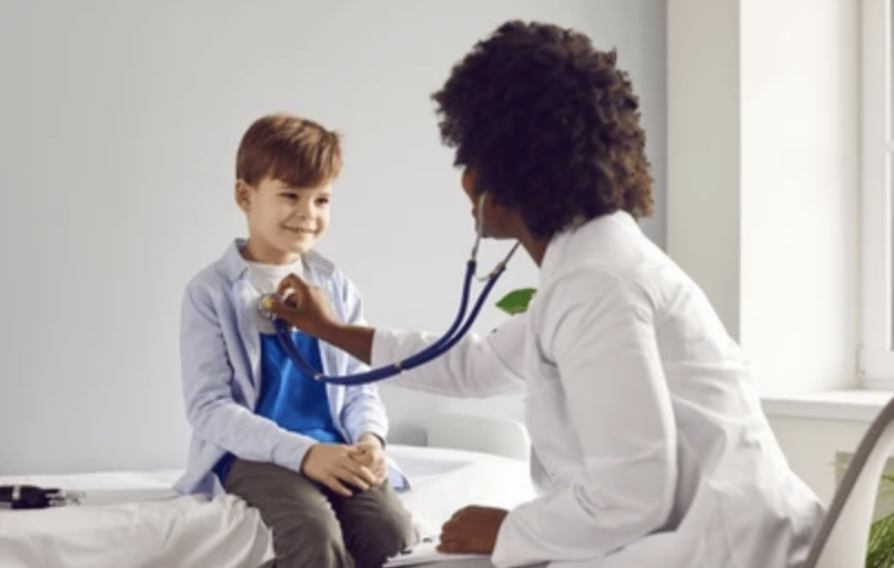 Pediatrician listening to a child's heartbeat